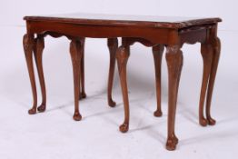 Walnut nest of tables standing on cabrio