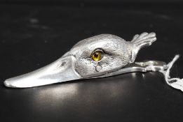 A silver plated paper clip in the form o