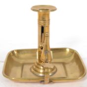 A 19th century brass chamber candlestick