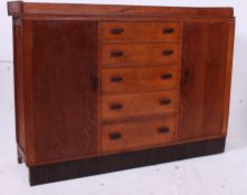An early 20th century Heals style oak si