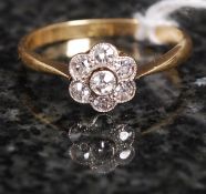An 18ct gold and diamond daisy head ring