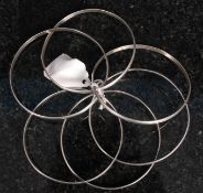 A near pair of silver puzzle bangles. On