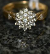 An 18ct gold ring with inset stones to t