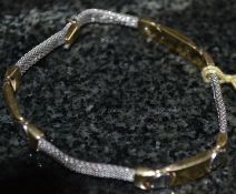 A 14ct white and yellow gold bracelet.