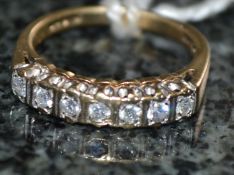 A 9ct gold seven stone diamond ring. 15p