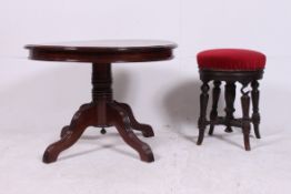 A Victorian revolving mahogany footstool
