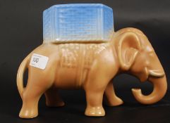 A Sylvac ? unusual brown and blue glazed figurine of an elephant.