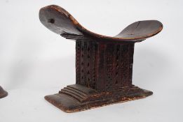A 19th century ? African Shanti tribal stool having a dished seat over fret pierced centre with