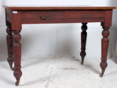 A 19th century Victorian mahogany writing table being raised on turned legs with twin drawers and