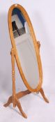 A 20th century contemporary antique style pine cheval mirror.