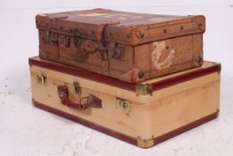 A good early 20th century leather suitcase having leather clasps with hinged centre and lined