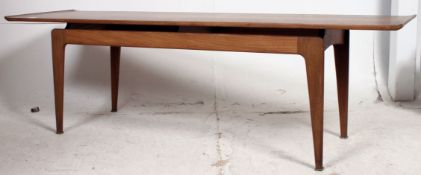 An excellent large Danish solid teak wood rectangular coffee table being raised on tapered supports