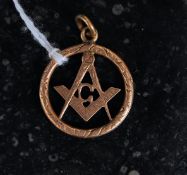 An unusual gold 9ct pendant of circular form with decorative measure and rule centre having ring