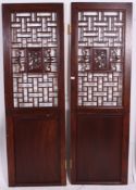 A pair of Chinese hardwood doors having recessed lower panels with fret pierced panels above.
191.