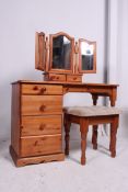 A 20th century contemporary pine dressing table having swing mirror and matching upholstered stool.