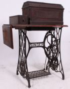 A 19th century Victorian Singer sewing machine table having cast iron base with machine above.