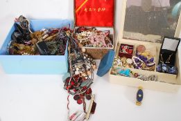 A large assortment of costume jewellery to include brooches,