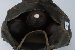 A collection of 3 vintage wooden bowling balls in bag by Taylor Rolfe & Co London