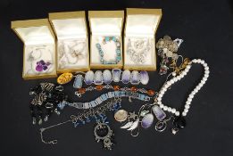 A collection of costume and silver jewellery to include cased necklaces,