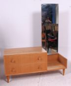 A 1970's retro oak drop centre dressing table with  large mirror over chest being raised on shaped