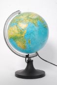 A 20th century retro desk top globe illuminating over plinth base with swivel action