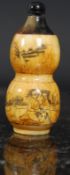 A Chinese bone and horn carved erotic snuff bottle. Twin ovoid form with erotic scene to front.