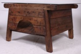 An industrial 19th century pine flour mill bin converted into a coffee table with toughened glass