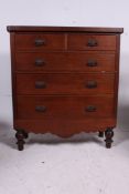 A Victorian mahogany 2 over 3 chest of drawer being raised on bun feet with 2 short drawers over 3