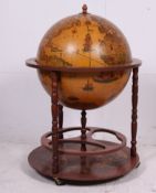 A retro 20th century globe cocktail cabinet having hinged centre with appointed interior set over