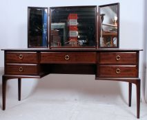 A Stag mahogany ' Minstrel ' dressing table raised on squared tapered supports having triptych