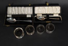 Two cased silver hallmarked spoons along with napkin rings, silver topped cut glass pot etc.
