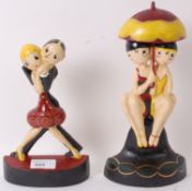 Two Art Deco style metal doorstop figurines.