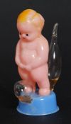 A vintage Empire Made curio of a urinating child,