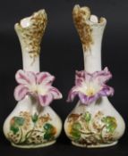 A pair of 20th century Staffordshire vases having waisted necks being embellished with flowers. 23.