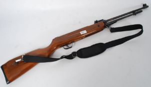 A .22 calibre 20th century underlever air rifle, full size with strap.