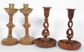 A  pair of 20th century Arts & Crafts candlesticks together with a wooden barleytwist pair