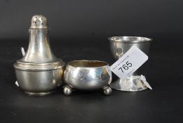 A silver hallmarked pepper pot by John Grinsell & Sons together with a silver hallmarked egg cup by