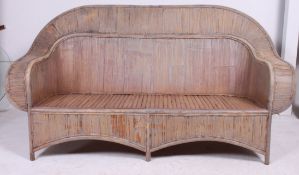 A 1930's style excellent shaped large bamboo plantation garden sofa bench having swept backrest and
