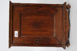 A Victorian solid  oak desk top smokers cabinet having central door and lined interior. 39.