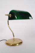 A contemporary bankers style desk lamp of normal form having green glass shade