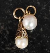 A 9ct gold teardrop pearl necklace pendant together with a 9ct gold round pearl pendant.