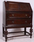 A 1920's solid oak Jacobean revival bureau / office desk.