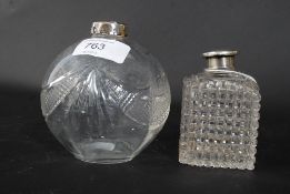 An Edwardian silver and cut glass hallmarked ladies perfume bottle  together with another bearing
