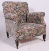 An Edwardian mahogany tapestry upholstered Chesterfield armchair being raised on tapered legs with
