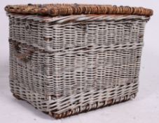 A good early 20th century whicker basket with hinged top and unusual metal hoop rings to the top,