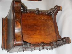A Victorian mahogany marquetry inlaid Davenport desk having hinged top with stationary cabinet atop.