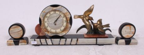A stunning Art Deco onyx and marble clock garniture,