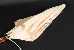 A hardwood and mother of pearl inlaid 20th century silk ladies parasol ( see illustration )