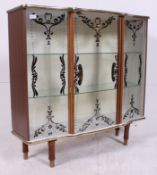 A vintage mid 20th century retro display cabinet having tapered supports with sliding glass doors