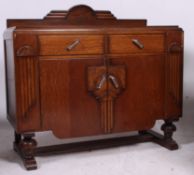 A 1930's oak sideboard / dresser having a series of cupboards and drawers with shaped top above.